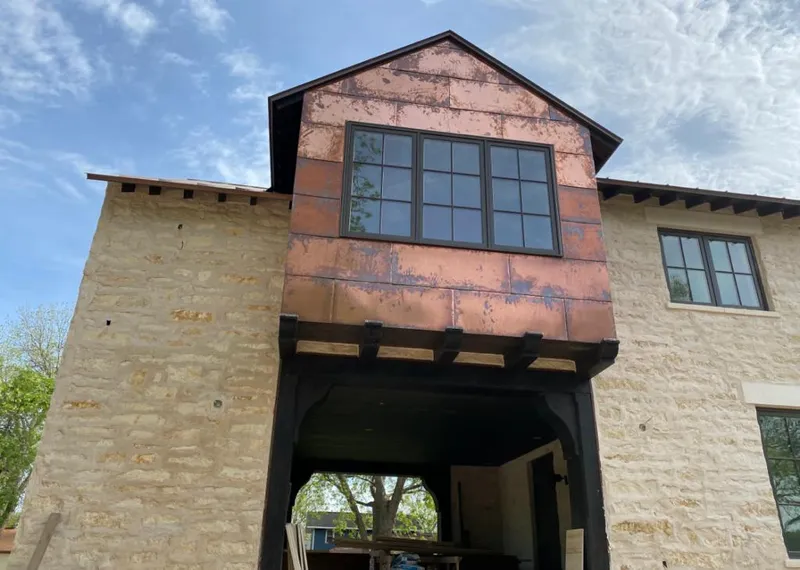 Copper metal panel facade on a stone building for Metal Roof Coating in Galax