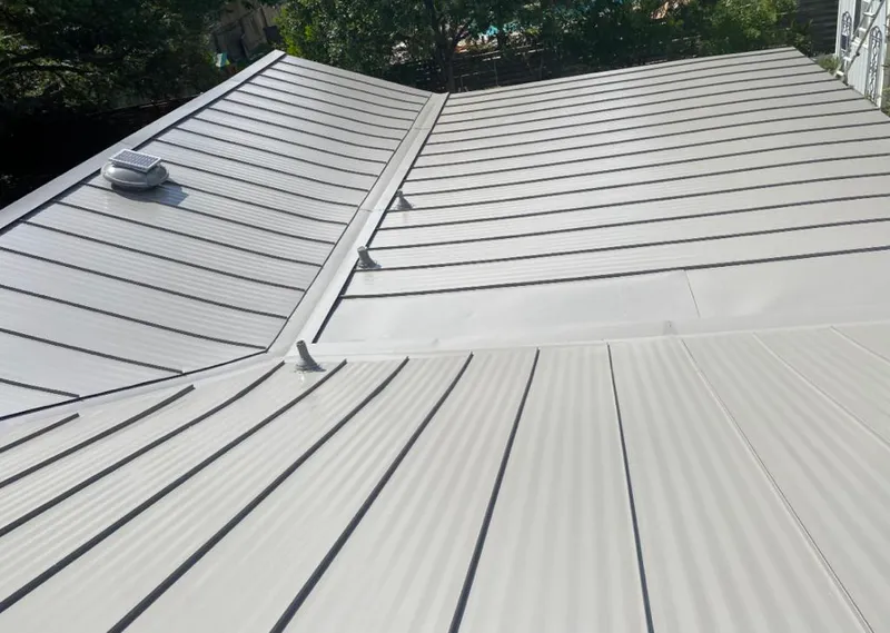 Solar attic fan installed on a metal roof for Roof Ventilation in Galax